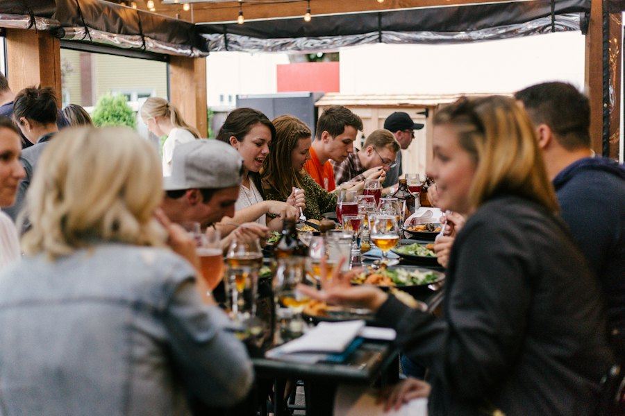 Friends sharing a meal around a restaurant table